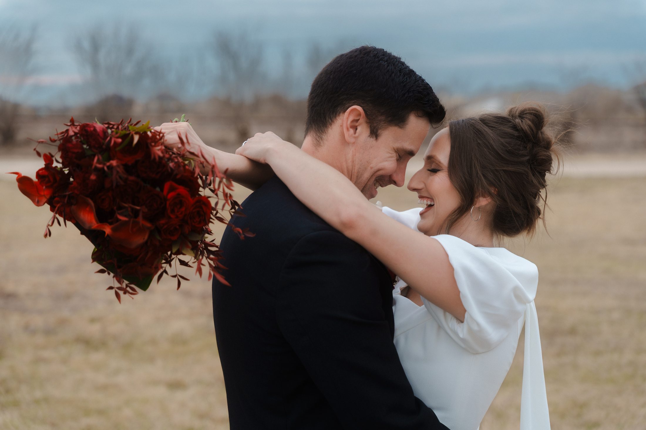 Wedding couple embracing outdoors